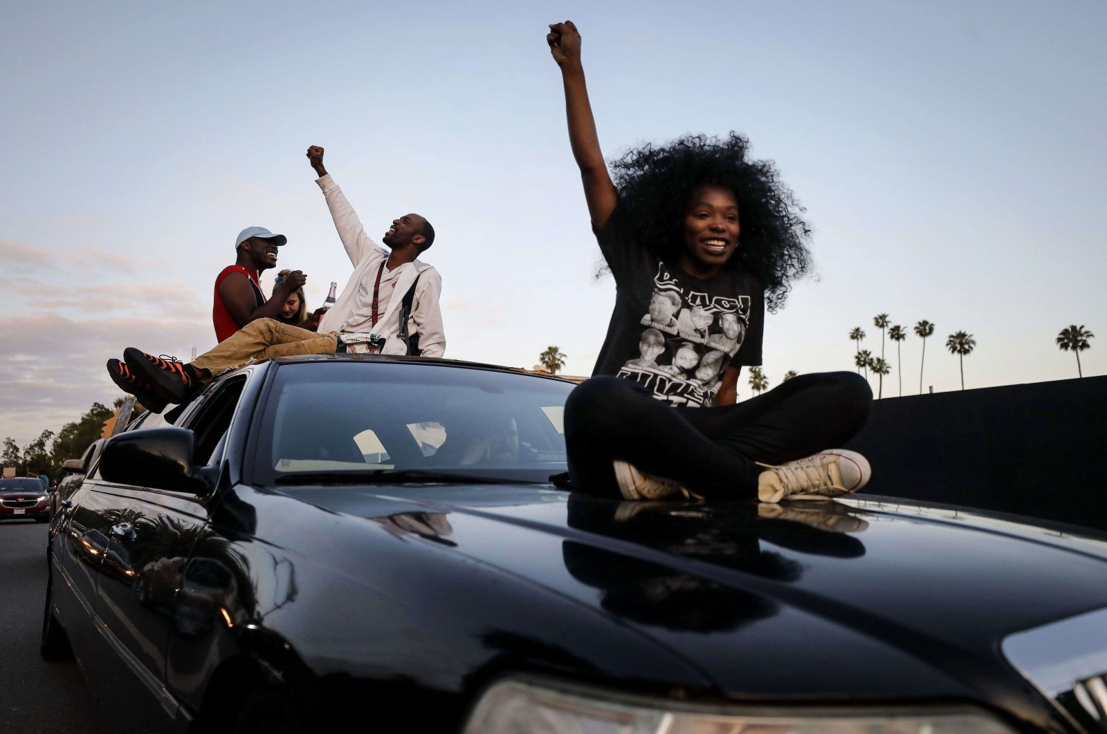 Protesters ride atop a limousine in a march toward Hollywood Boulevard during a peaceful demonstration against racism and police brutality, Los Angeles, California, June 6, 2020. (AFP Photo)