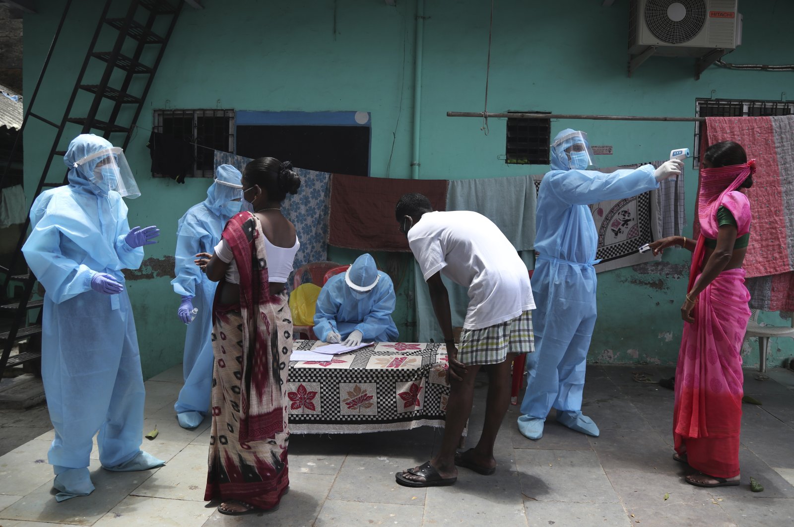 Doctors examine people during a free medical camp, Dharavi, Mumbai, India, June 7, 2020. (AP Photo)