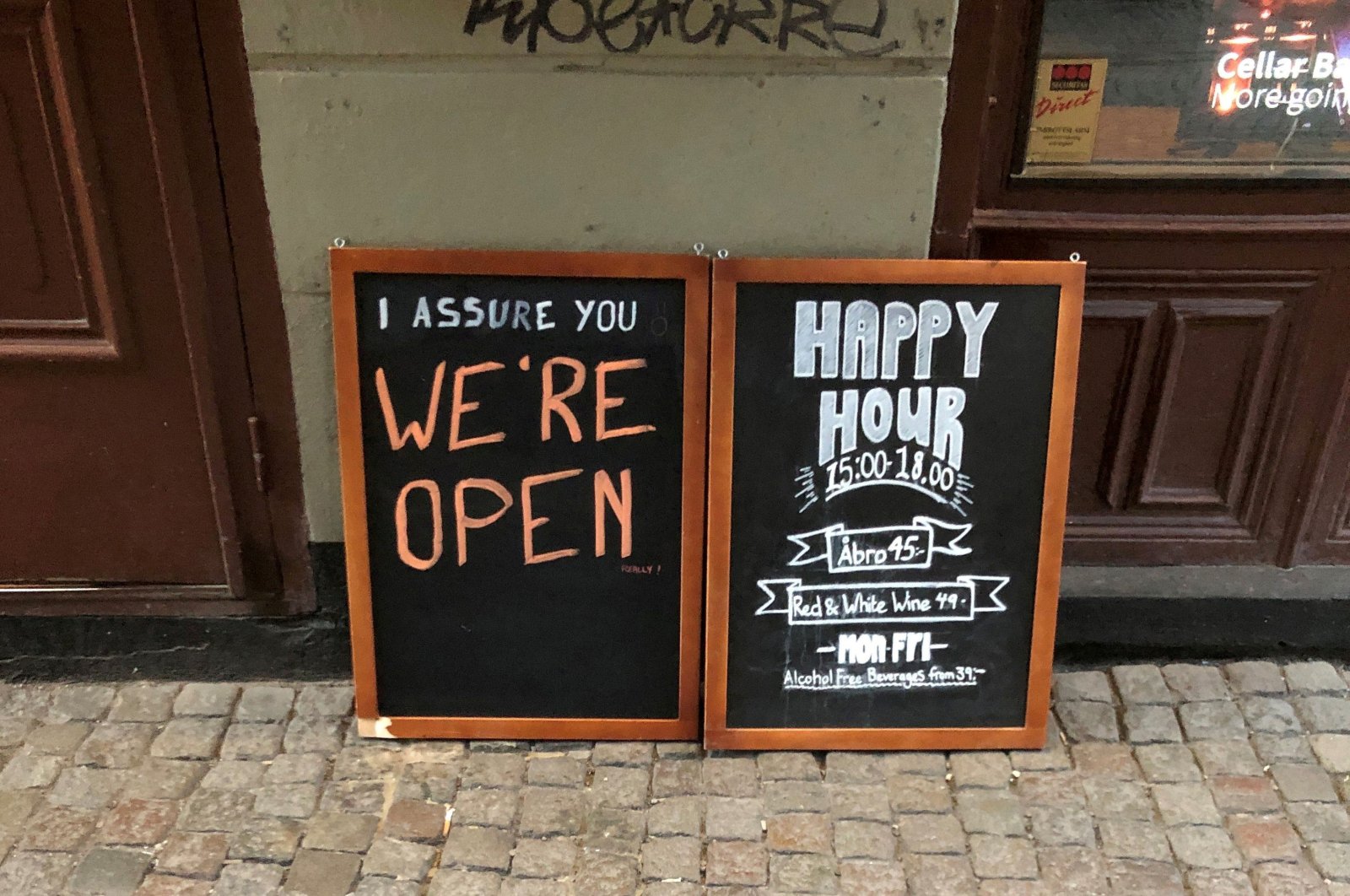 A sign assures people that a bar is open during the coronavirus outbreak, outside a pub in Stockholm, Sweden, March 26, 2020. (Reuters Photo)