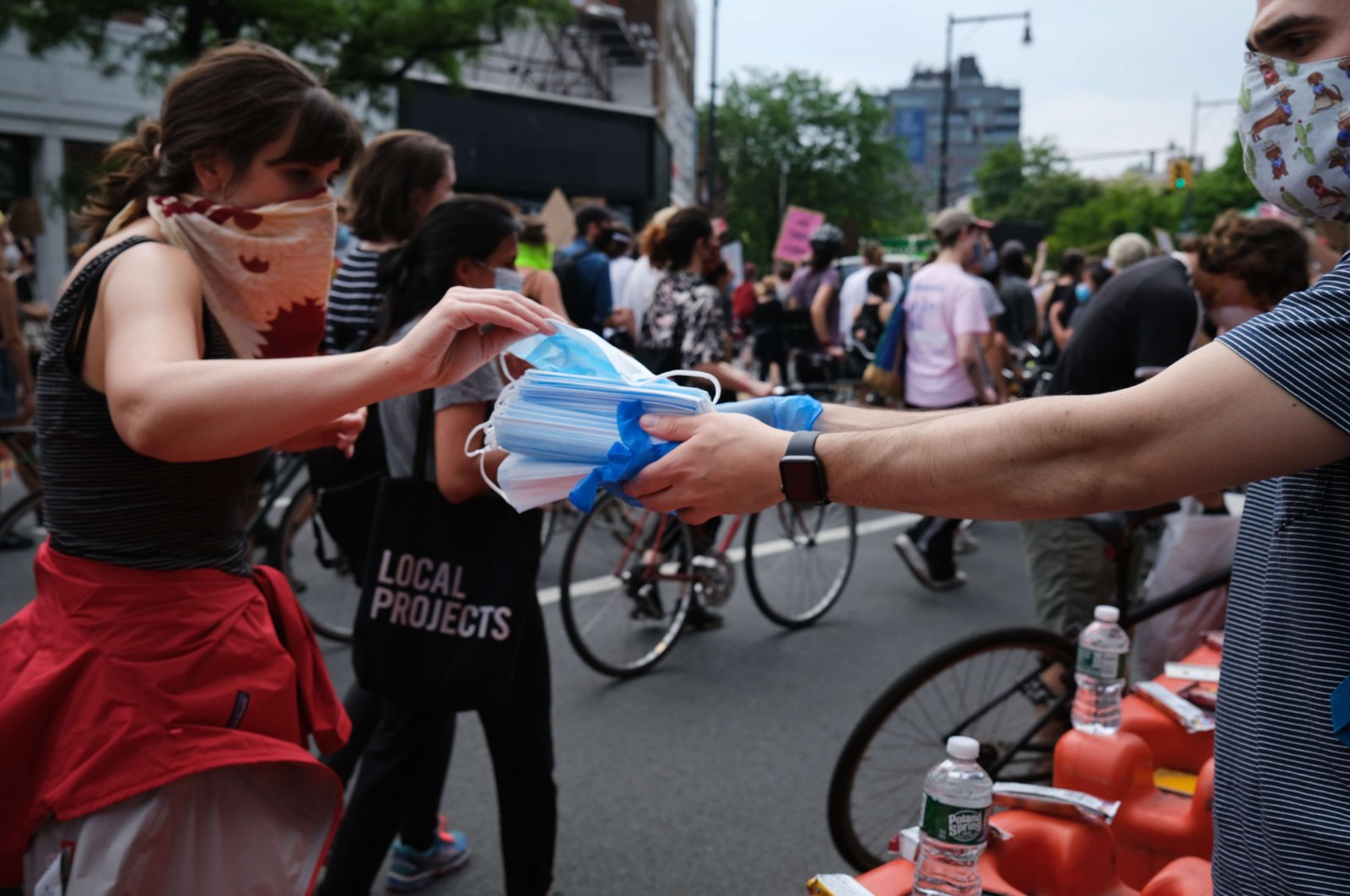 Face masks are handed out as hundreds of protesters march in downtown Brooklyn over the killing of George Floyd by a Minneapolis Police officer on June 5, 2020, in New York City, New York, U.S. (Getty Images/AFP)