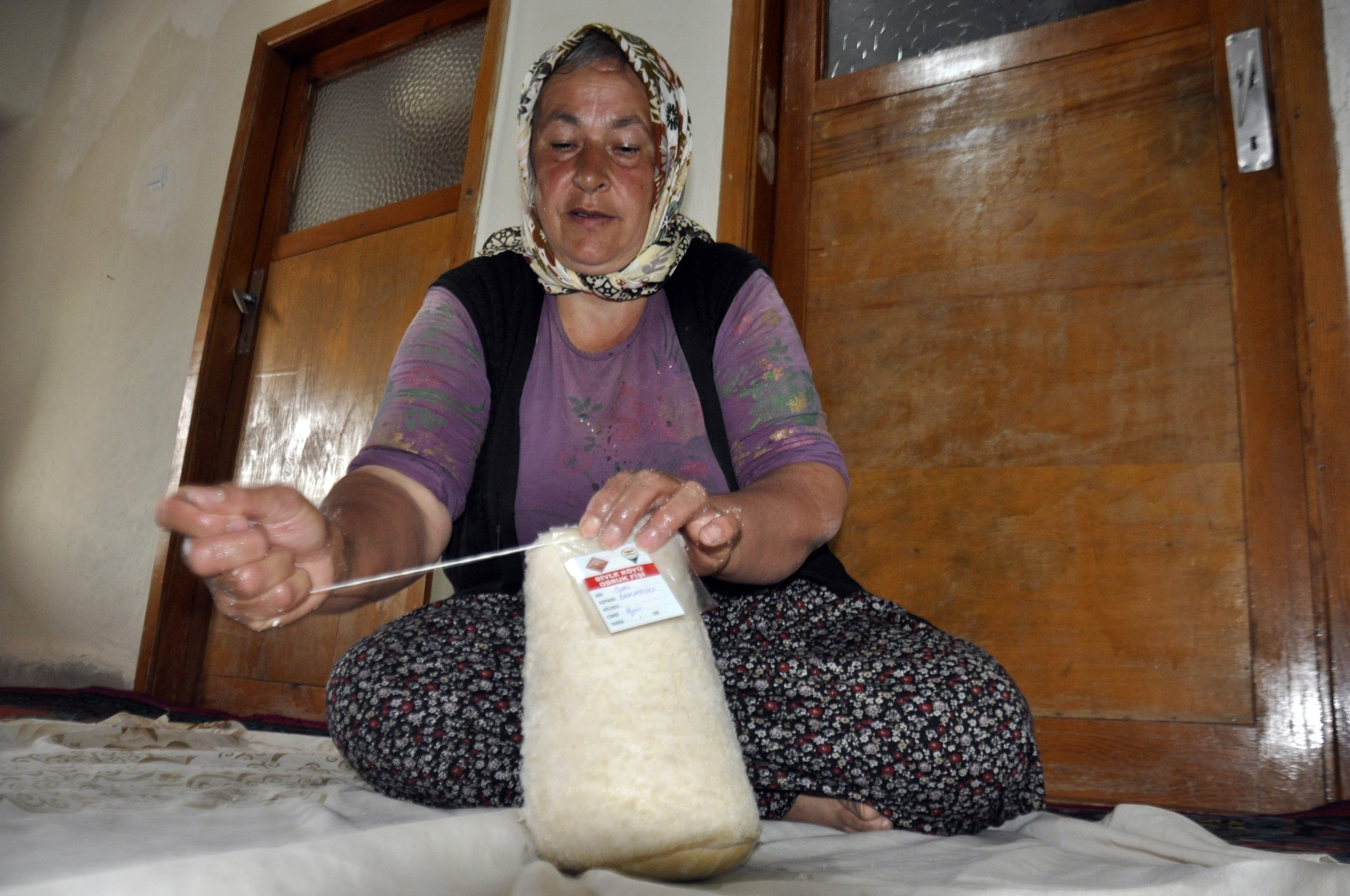 Locals carefully sew sheep or goat skins to create special sacks for the cheese. (DHA Photo)