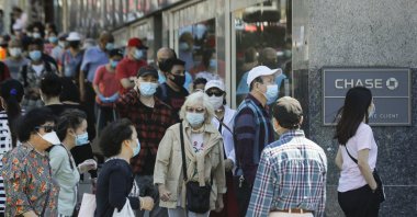 Patrons wearing protective masks wait to enter a Chase Bank location in the Flushing section of the Queens borough of New York City, New York, U.S., June 8, 2020. (AP Photo)