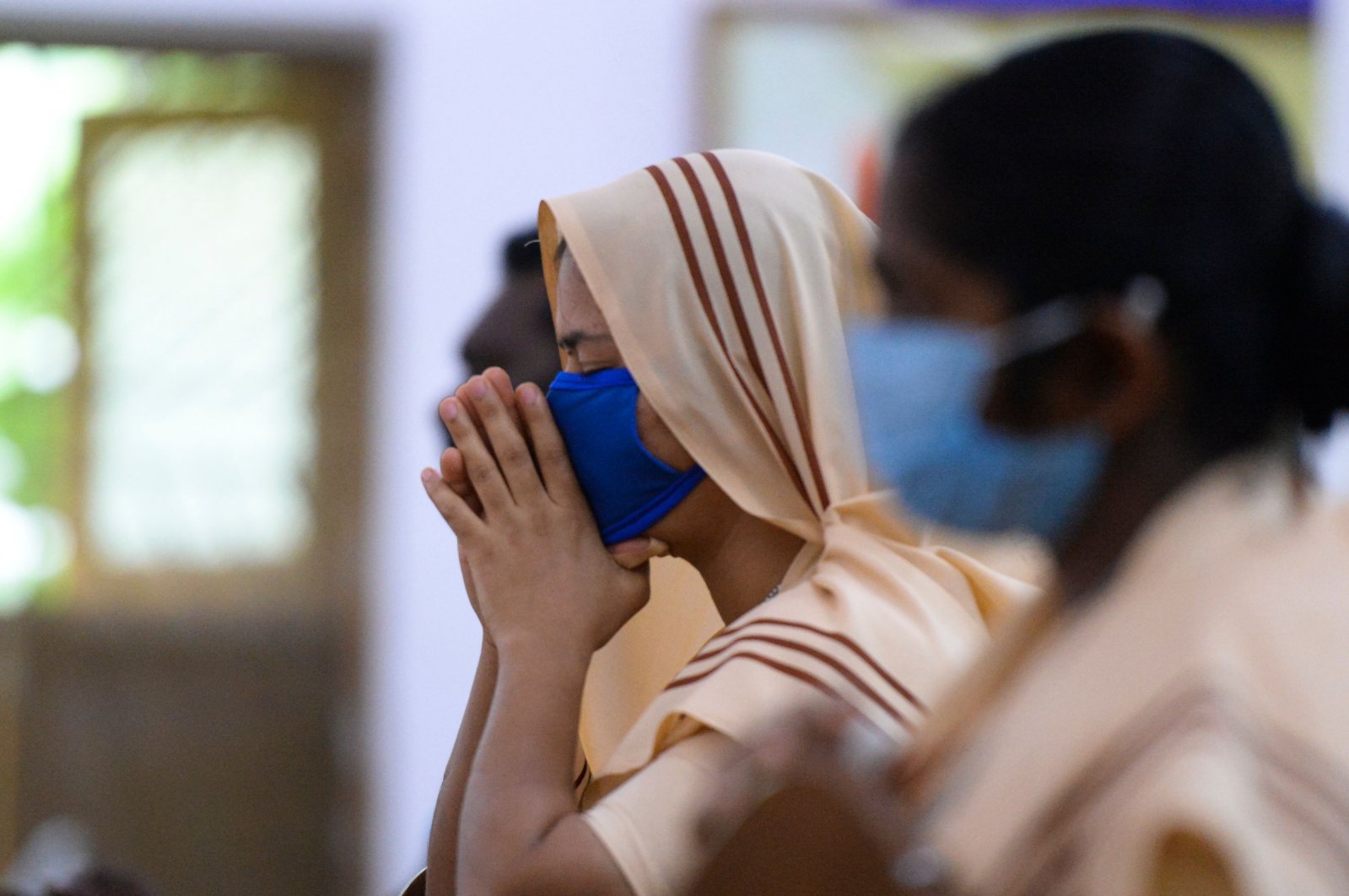 A Catholic nun wearing a face mask attends a Mass service at Saint Joseph's Church, Hyderabad, India, June 8, 2020. (AFP Photo)