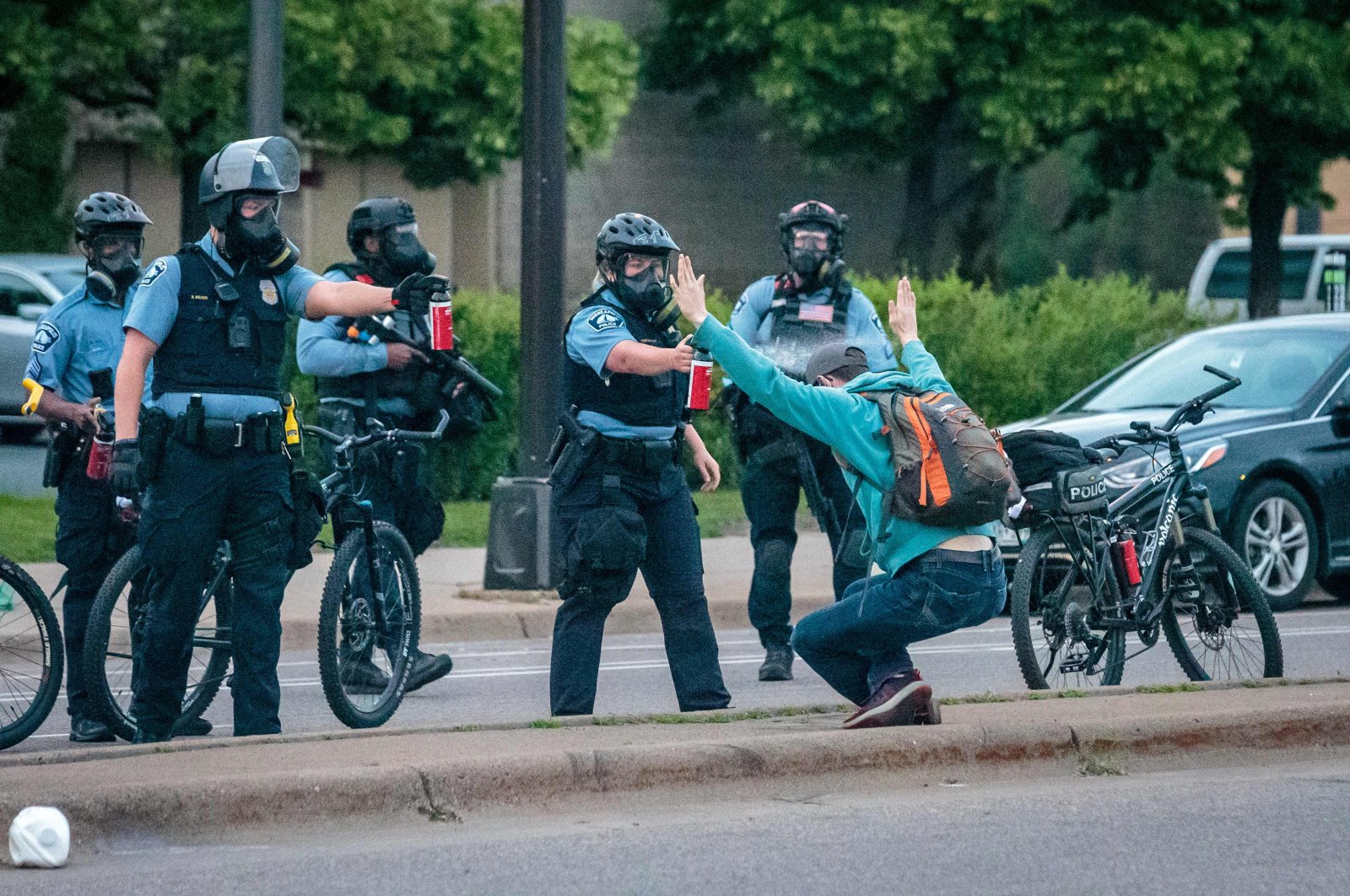Demonstrator holds up his hands as he is sprayed with pepper spray by two Minneapolis Police officers in Minneapolis, Minnesota during a protest over the death of George Floyd, an unarmed black man who died while in police custody in Minneapolis, May 31, 2020. (AFP Photo)