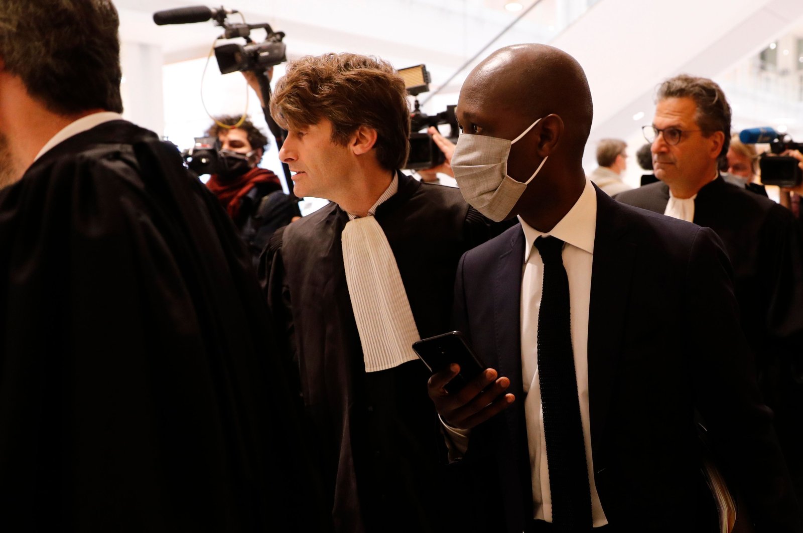 Habib Cisse (R), Diack's former legal advisor, arrives at a courthouse in Paris for the trial of Lamine Diack (not pictured), former head of the International Association of Athletics Federations (now World Athletics), on charges of accepting millions of dollars to cover up Russian doping tests, June 8, 2020. (AFP Photo)