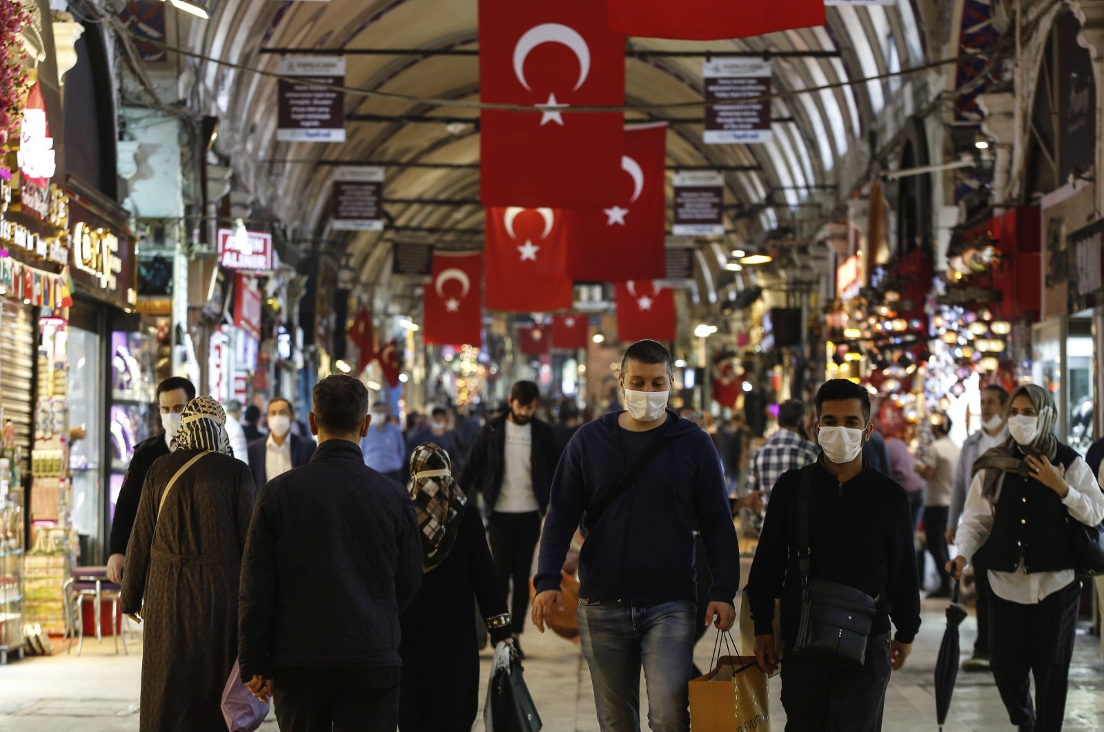 People wearing protective face masks walk at the iconic 15th century Grand Bazaar in Istanbul, Turkey, Monday June 1, 2020. (AP Photo)