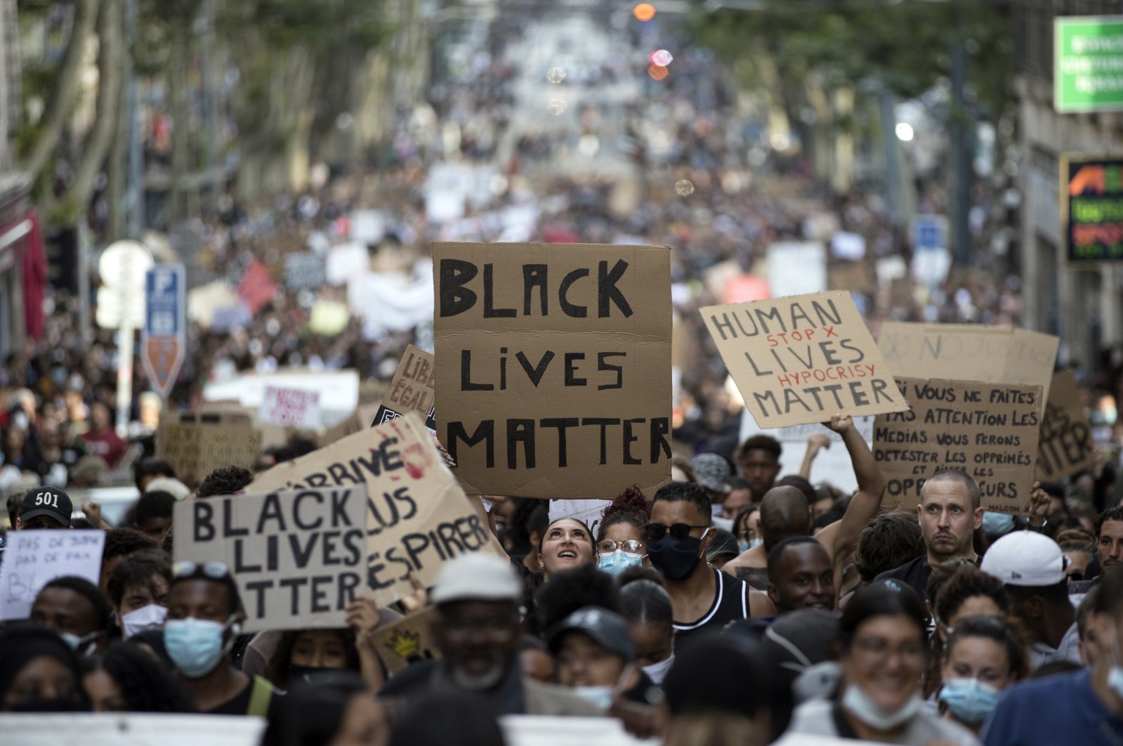 A protester looks up at a sign that reads "Black Lives Matter" in Marseille, southern France, during a protest against the recent death of George Floyd, June 6, 2020. (AP Photo)