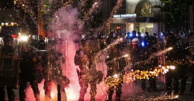 Fireworks go off in front of police at a protest in front of police headquarters in St. Louis, Missouri, U.S., June 1, 2020. (AP Photo)
