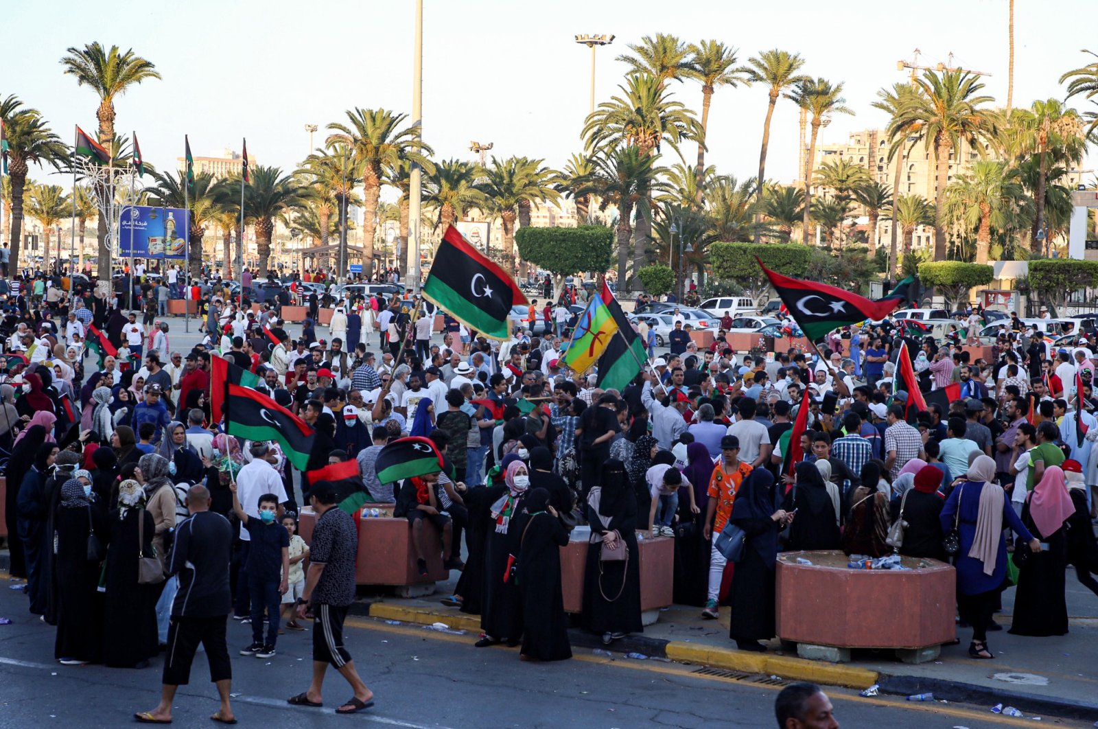 People celebrate with Libyan national flags in the capital Tripoli's Martyrs' Square, after the U.N.-recognized Government of National Accord (GNA) captured the town of Tarhuna from forces loyal to putschist Gen. Khalifa Haftar, June 5, 2020. (AFP Photo)
