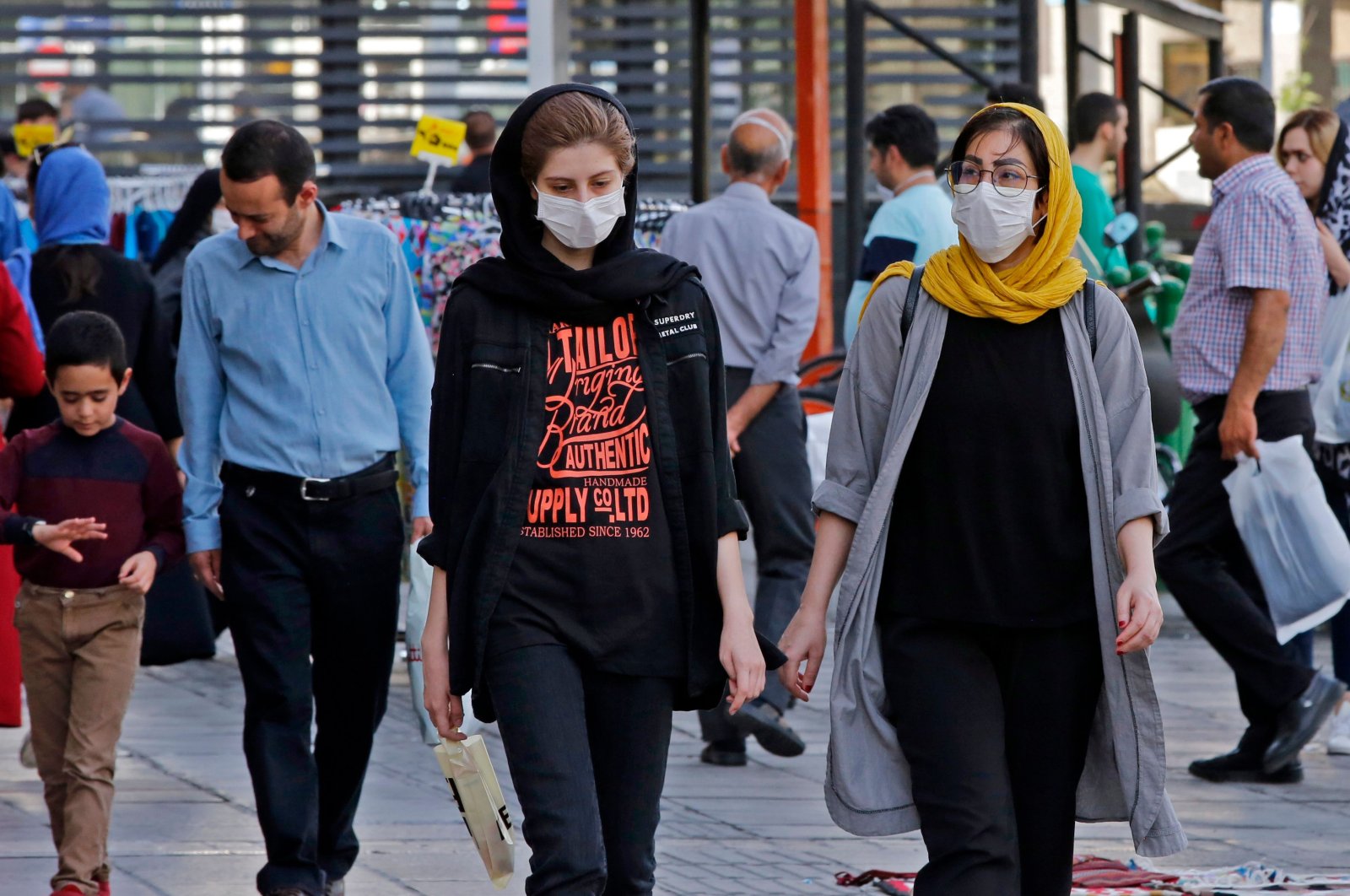 Iranians, some wearing face masks, walk along a street, Tehran, Iran, June 3, 2020. (AFP Photo)