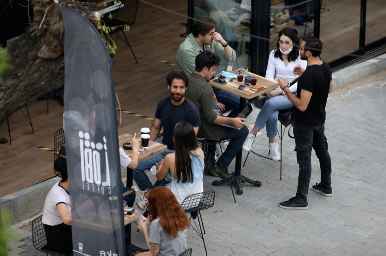 People sit outside a cafe, in Ankara, Turkey, Saturday, June 6, 2020. (AP Photo)