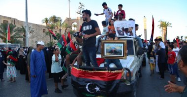 People celebrate with Libyan national flags in the capital Tripoli's Martyrs' Square after fighters loyal to the U.N.-recognized Government of National Accord (GNA) captured the town of Tarhuna, June 5, 2020. (AA Photo)