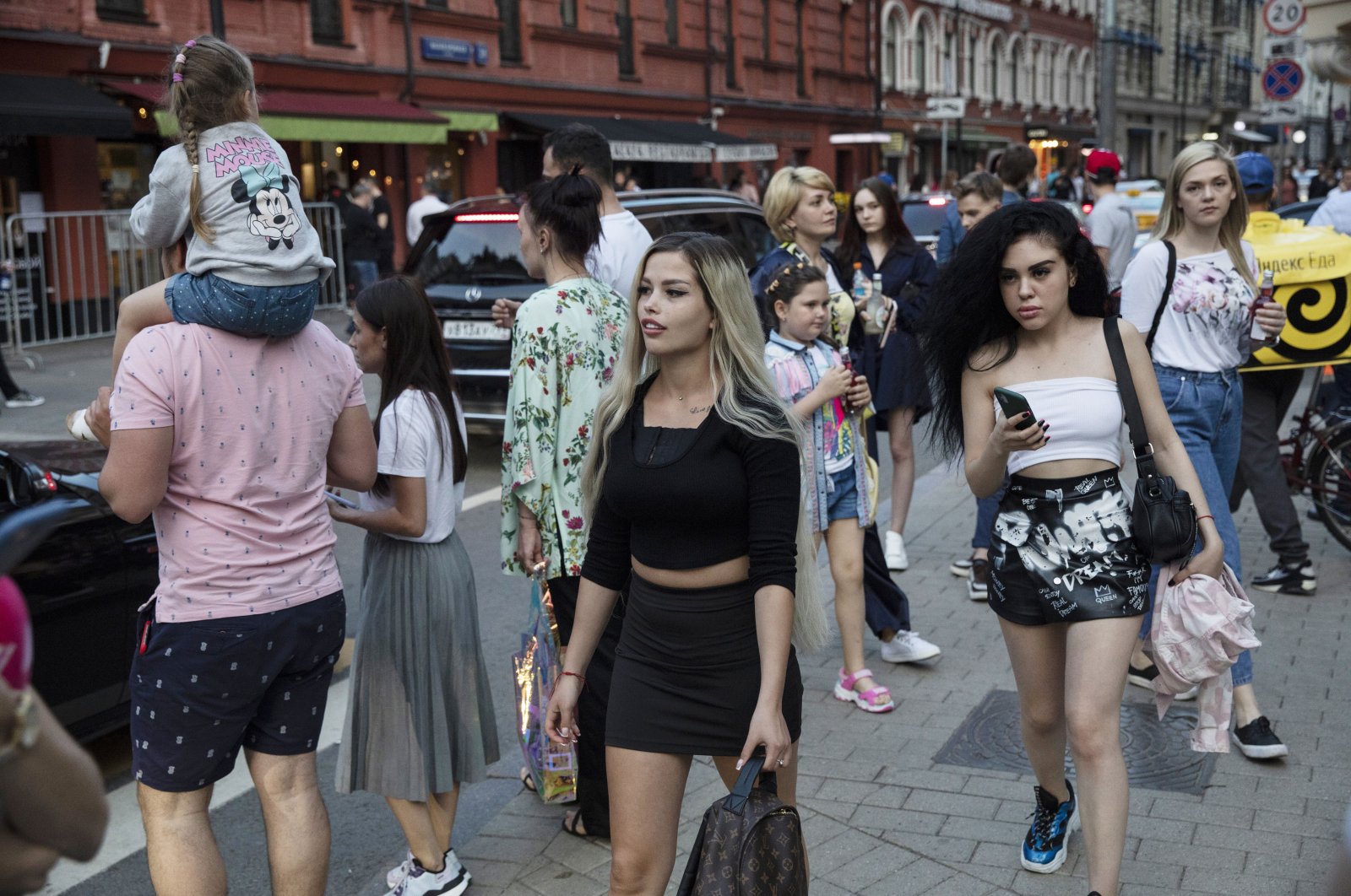 People walk on the first day that lockdown measures were eased at Patriarch Ponds in Moscow, Russia, June 9, 2020. (AP Photo)