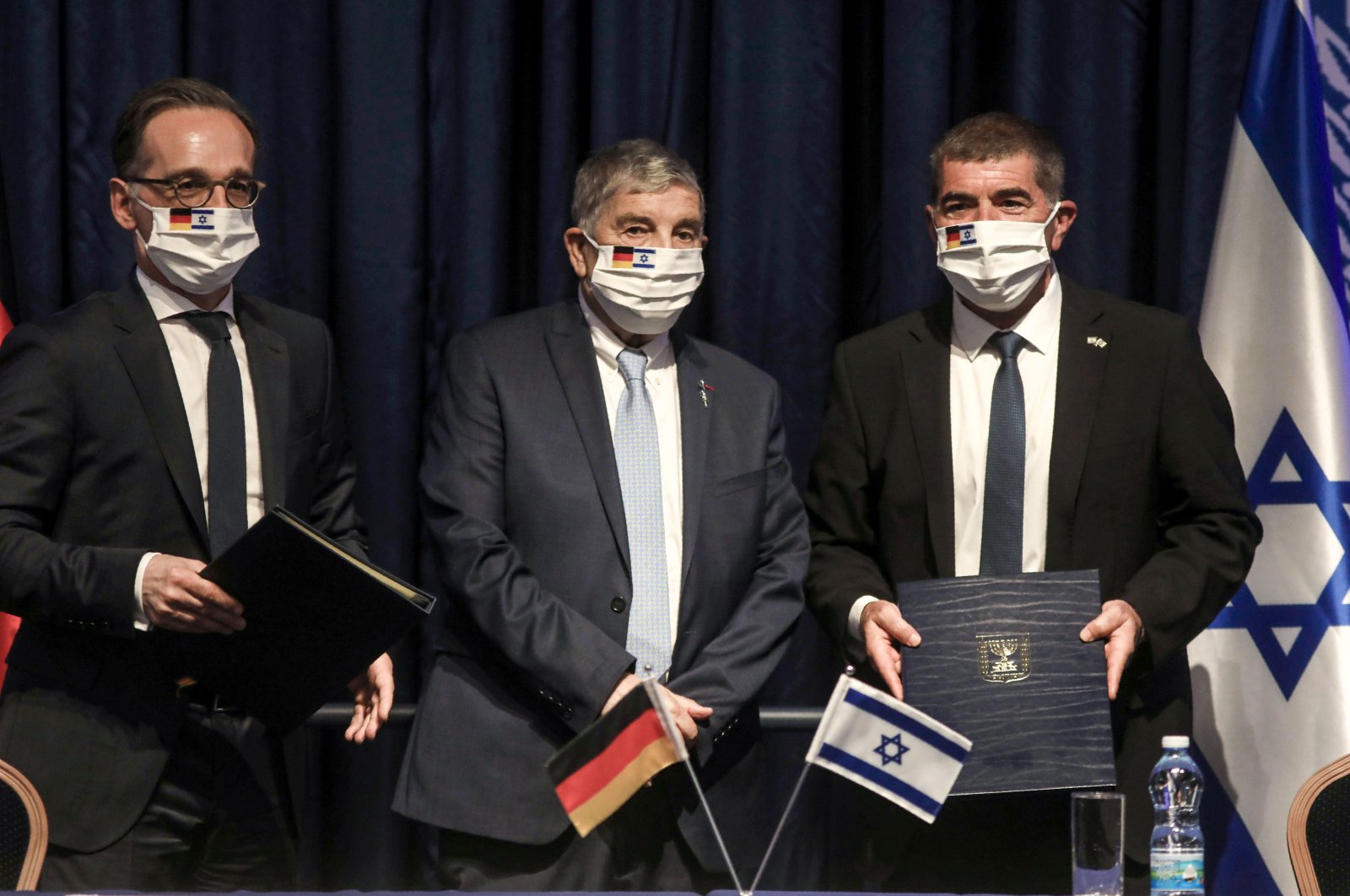 German Foreign Minister Heiko Maas (L), chairman of the Yad Vashem Holocaust Remembrance Center Avner Shalev (C) and Israeli Foreign Minister Gabi Ashkenazi (R) pose for a picture together after signing an agreement at the ministry headquarters in Jerusalem, Israel, June 10, 2020. (AFP Photo)