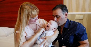 Jose Perez and Flavia Lavorino from Buenos Aires react during their first meeting with their son Manuel, who was born to a surrogate mother in a Ukrainian BioTexCom clinic in Kyiv, Ukraine, June 10, 2020. (Reuters Photo)