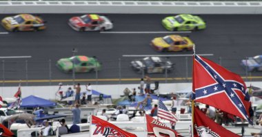 A Confederate flag flies in the infield as cars come out of Turn 1 during a NASCAR auto race at Talladega Superspeedway in Talladega, Ala., Oct. 7, 2007. (AP File Photo)
