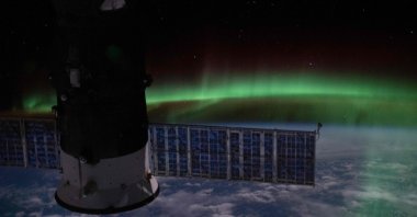 This handout photo released June 10, 2020, shows an orbital nighttime view from the International Space Station as it orbits above the Indian Ocean with the "aurora australis" and a starry sky with Russia's Progress 74 resupply ship in the foreground on June 7, 2020. (NASA via AFP)