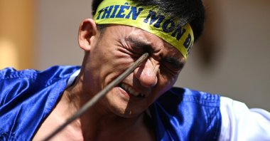 Le Van Thang, 28, a student of the centuries-old martial art of Thien Mon Dao, bends a construction rebar against his eye socket inside the Bach Linh temple compound at Du Xa Thuong village in Hanoi, Vietnam, June 7, 2020. (AFP Photo)