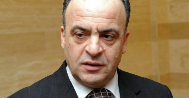Then-electricity minister Imad Khamis answering journalists' questions following a meeting in the Syrian capital Damascus, January 16, 2014.