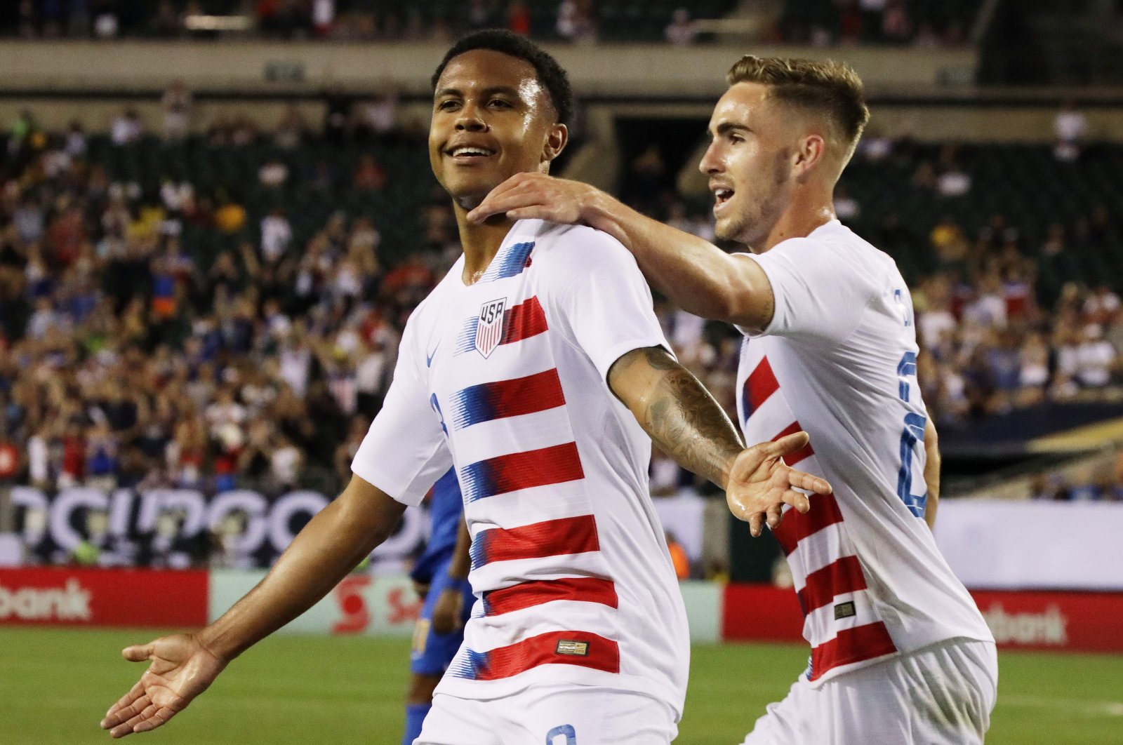 This July 1, 2019, file photo shows U.S.' Tyler Boyd, right, congratulating his teammate Weston McKennie after McKennie scored a goal during the CONCACAF Gold Cup quarterfinal football match between the U.S. and Curacao in Philadelphia, Penn. (AFP Photo)