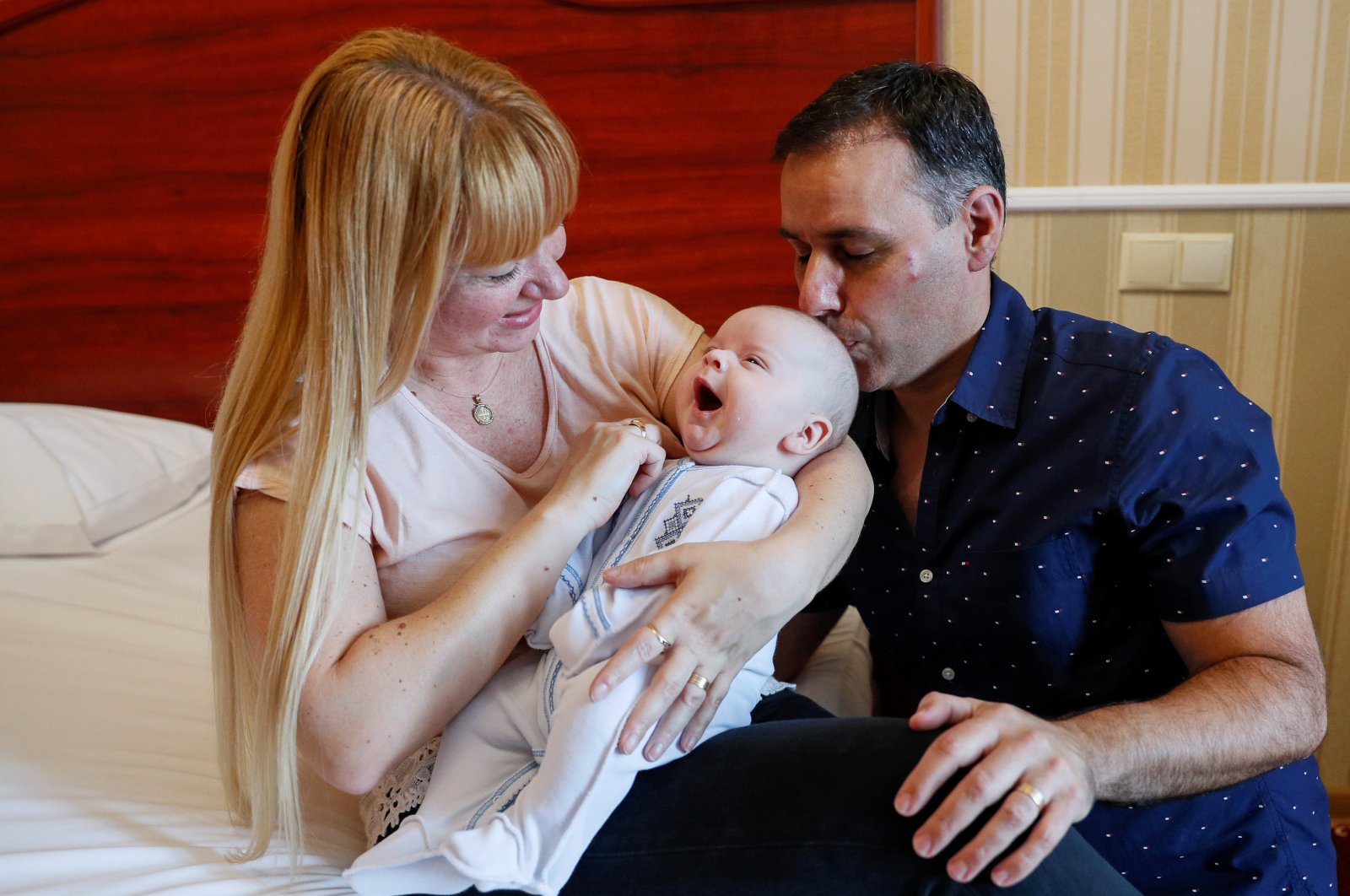 Jose Perez and Flavia Lavorino from Buenos Aires react during their first meeting with their son Manuel, who was born to a surrogate mother in a Ukrainian BioTexCom clinic in Kyiv, Ukraine, June 10, 2020. (Reuters Photo)