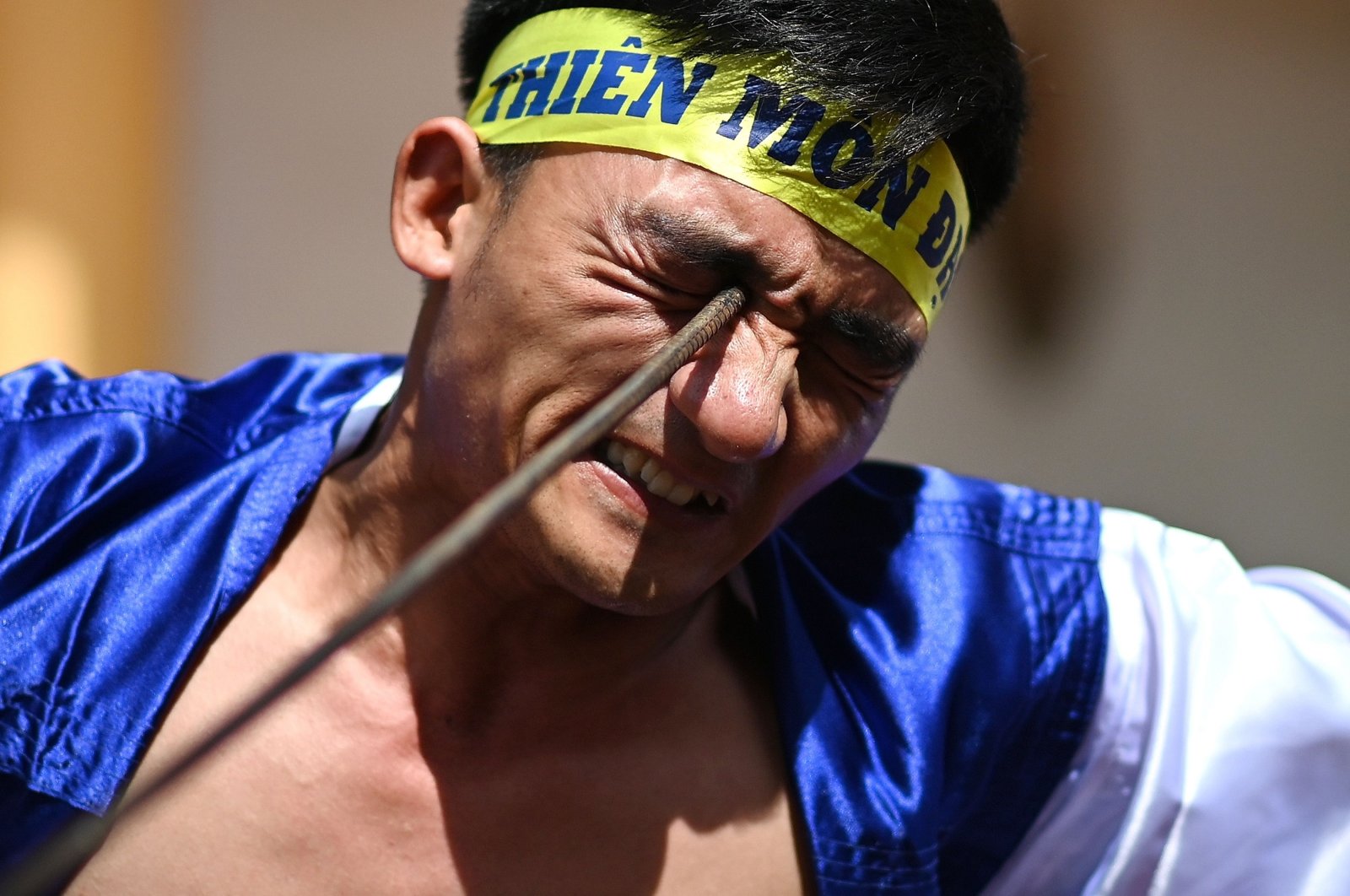 Le Van Thang, 28, a student of the centuries-old martial art of Thien Mon Dao, bends a construction rebar against his eye socket inside the Bach Linh temple compound at Du Xa Thuong village in Hanoi, Vietnam, June 7, 2020. (AFP Photo)
