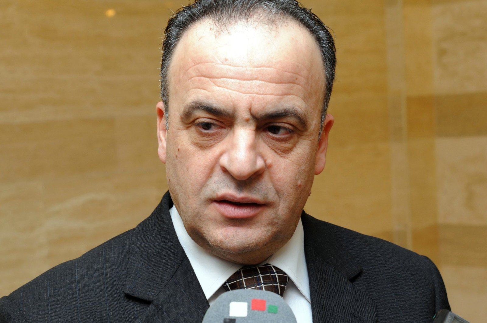 Then-electricity minister Imad Khamis answering journalists' questions following a meeting in the Syrian capital Damascus, January 16, 2014.