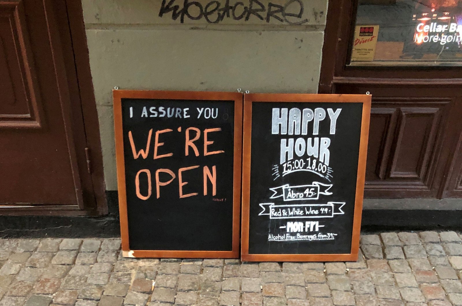 A sign assures people that the bar is open during the coronavirus outbreak, outside a pub in Stockholm, March 26, 2020. REUTERS