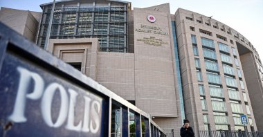 In this file photo, a woman walks in front of a courthouse in Istanbul during the trial of Metin Topuz, a U.S. Consulate employee accused of spying and attempting to overthrow the government, Dec. 11, 2019. (AFP Photo)