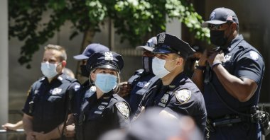 New York Police Officers watch protesters gathered near Trump Tower as part of a solidarity rally calling for justice over the death of George Floyd, and to highlight police brutality nationwide, New York, NY, June 12, 2020. (AP Photo)