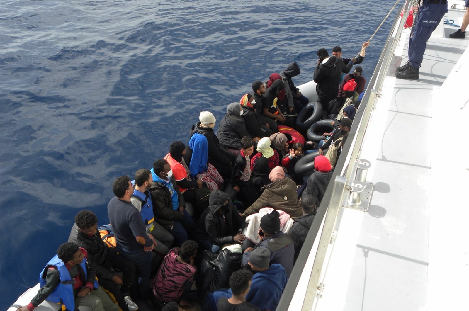 Turkey's Coast Guard Command rescues 42 asylum-seekers from a boat pushed back by Greece's Hellenic Coast Guard, in Izmir province's Foça district, Turkey, June 12, 2020. (DHA Photo)