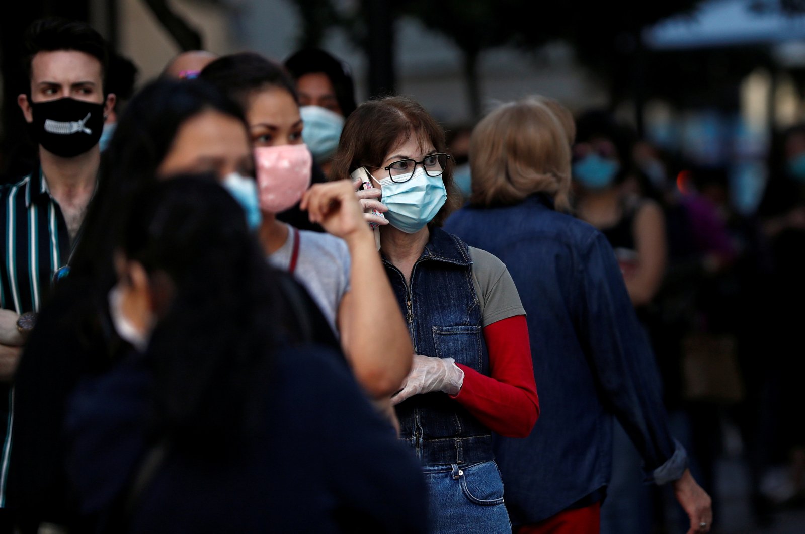 People wearing face masks queue to enter a reopened Primark store as Madrid eases lockdown restrictions following the coronavirus disease (COVID-19) outbreak, in Madrid, Spain, June 11, 2020. (Reuters Photo)