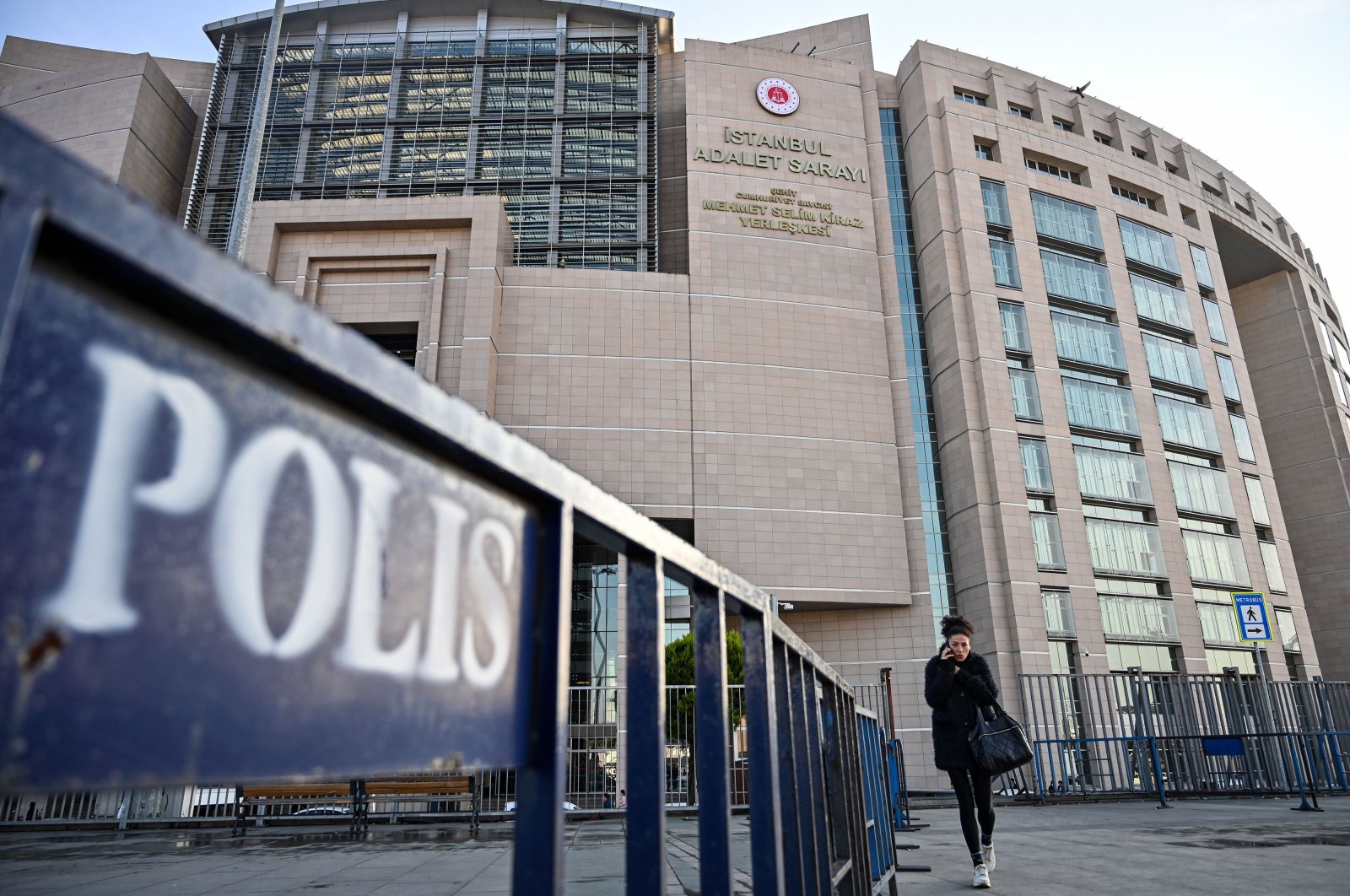 In this file photo, a woman walks in front of a courthouse in Istanbul during the trial of Metin Topuz, a U.S. Consulate employee accused of spying and attempting to overthrow the government, Dec. 11, 2019. (AFP Photo)