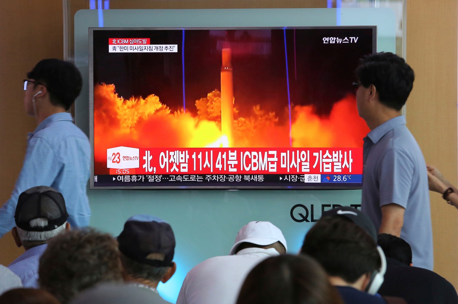 People watch a TV news program showing an image of North Korea's latest test launch of an intercontinental ballistic missile (ICBM), at the Seoul Railway Station in Seoul, South Korea, July 29, 2017. (AP Photo)