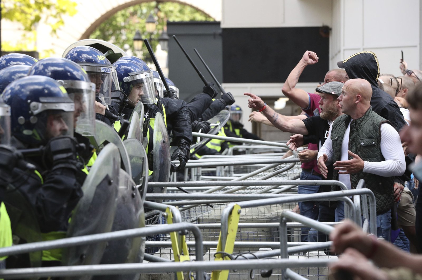 Police are confronted by protesters from the Democratic Football Lads Alliance on June 13, 2020.  The death of George Floyd in the United States has prompted demonstrations by the Black Lives Matter movement and counter-protests by racist, far-right groups, provoking a wider debate on Britain's colonial past. (AP Photo)