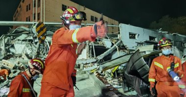 Rescuers work on a damaged building in the aftermath of an oil tanker explosion in Wenling, Zhejiang province, China, June 14, 2020. (EPA-EFE Photo)