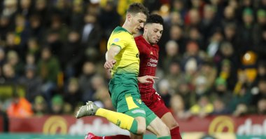 Norwich City's Max Aarons, front, duels for the ball with Liverpool's Alex Oxlade-Chamberlain during a Premier League match in Norwich, England, Feb. 15, 2020. (AP Photo)