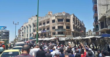 A handout picture released by the local news site Suwayda 24 shows Syrians chanting anti-regime slogans as they protest the country's deteriorating economic conditions and corruption, in the southern city of Suwaida, June 9, 2020. (SUWAYDA24 / AFP Photo)
