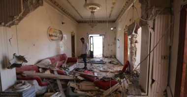 A Syrian man inspects his damaged house following a bombardment by regime forces on the village of Balyun, southern countryside of Syria's northwestern province of Idlib, June 6, 2020. (AFP Photo)