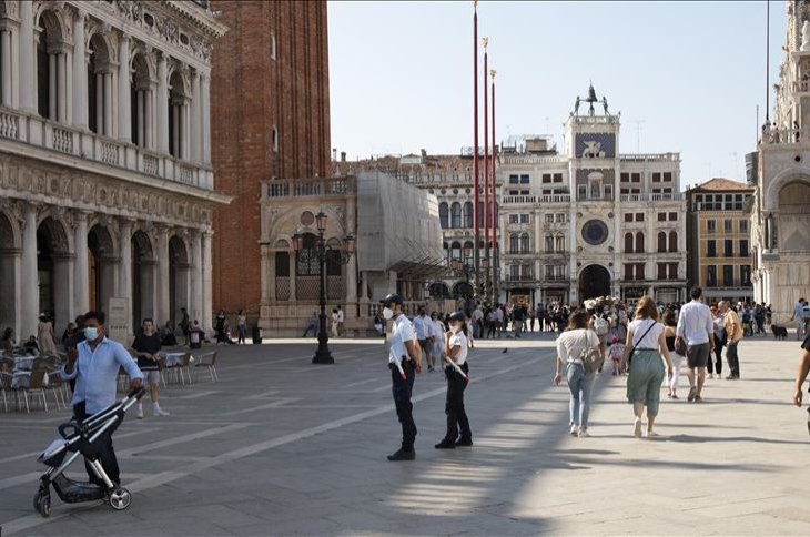 As Italy has eased the lockdown aimed at curbing the spread of the COVID-19 infection, local police officers wearing protective face masks patrol San Marco Square in Venice, Italy, June 13, 2020. ( AA Photo)