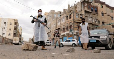 Security men wearing protective masks stand on a street during a 24-hour curfew amid concerns about the spread of the coronavirus, Sanaa, Yemen, May 6, 2020. (Reuters Photo)
