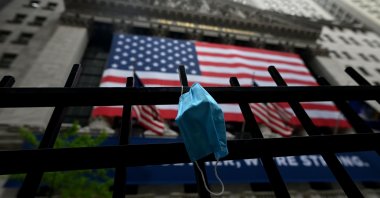 A face mask is seen in front of the New York Stock Exchange (NYSE), at Wall Street in New York City, New York, U.S., May 26, 2020. (AFP Photo)