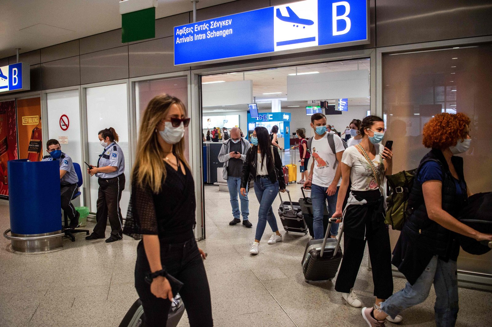 Passengers of a flight from Paris wearing protective face masks arrive at the Eleftherios Venizelos International Airport in Athens, June 15, 2020. (AFP Photo)