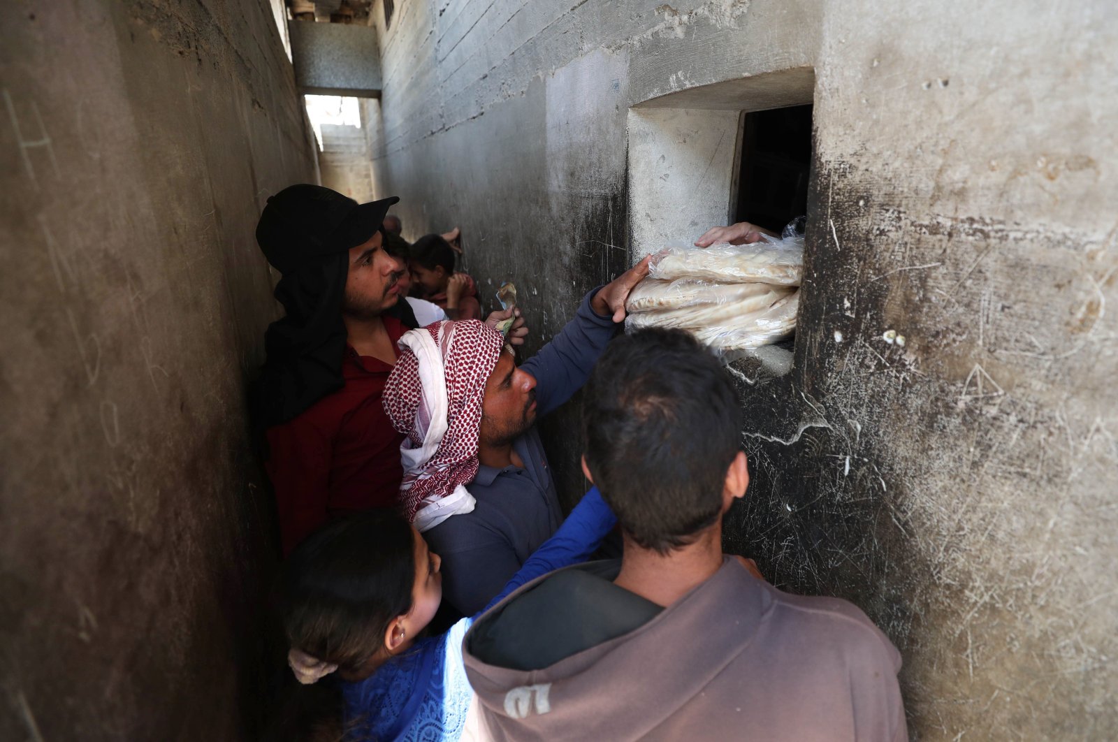 Syrians buy bread at a shop in the town of Binnish in the country's northwestern Idlib province, June 9, 2020. (AFP Photo)