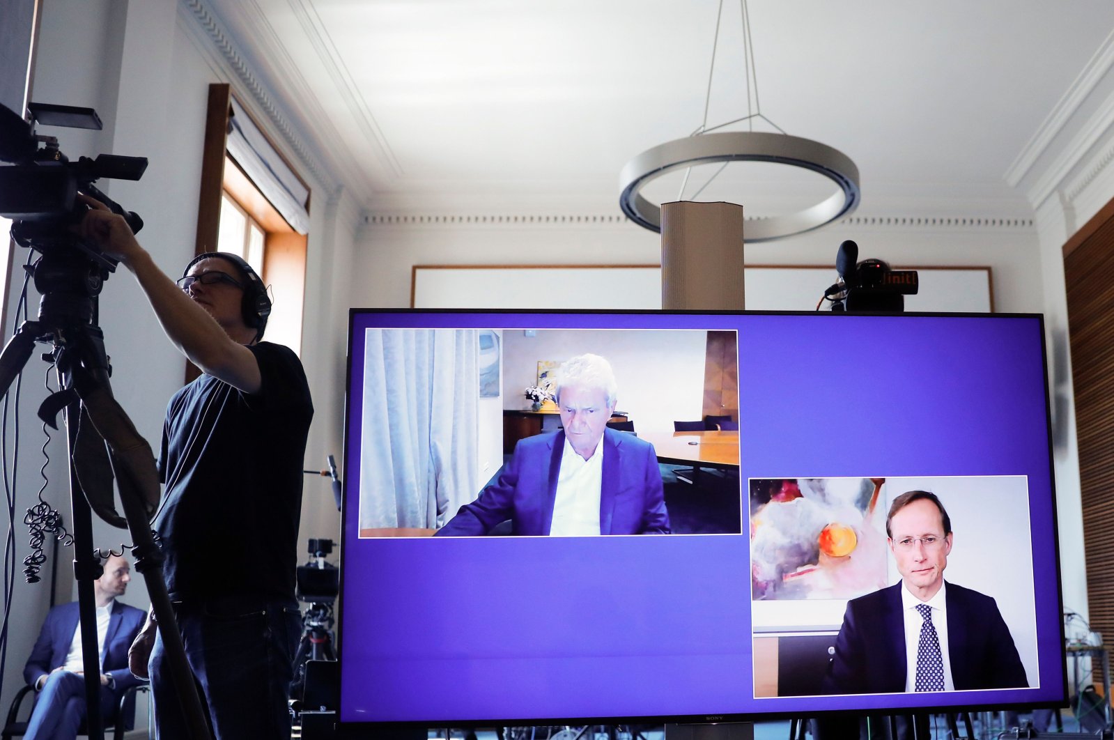 CureVac main shareholder Dietmar Hopp (L) and CureVac CEO Franz-Werner Haas are displayed on a screen during a news conference at the economy ministry in Berlin, Germany, June 15, 2020. (AFP Photo)