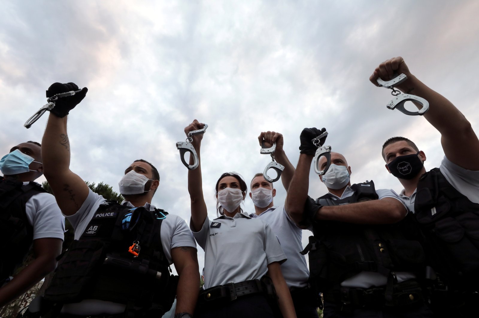 Police officers hold handcuffs in the air during a protest against French Interior Minister Christophe Castaner's reforms, including ditching a controversial chokehold method of arrest, Nice, France June 12, 2020. (Reuters Photo)