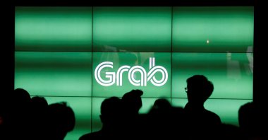 People wait for the start of Grab's fifth anniversary news conference in Singapore June 6, 2017. (Reuters Photo)