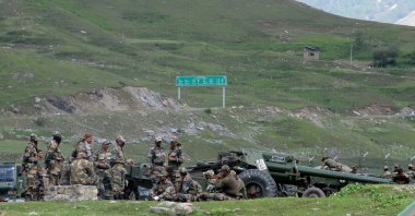 Indian army soldiers rest next to artillery guns at a makeshift transit camp before heading to Ladakh, near Baltal, southeast of Srinagar, June 16, 2020. (Reuters Photo)