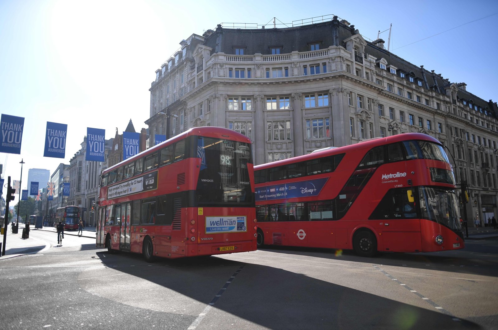 Various stores and outdoor attractions in England opened on June 15 for the first time in nearly three months, as the government continues to ease its coronavirus lockdown. Pictured are buses crossing Oxford Circus in London, June 16, 2020. (AFP Photo)