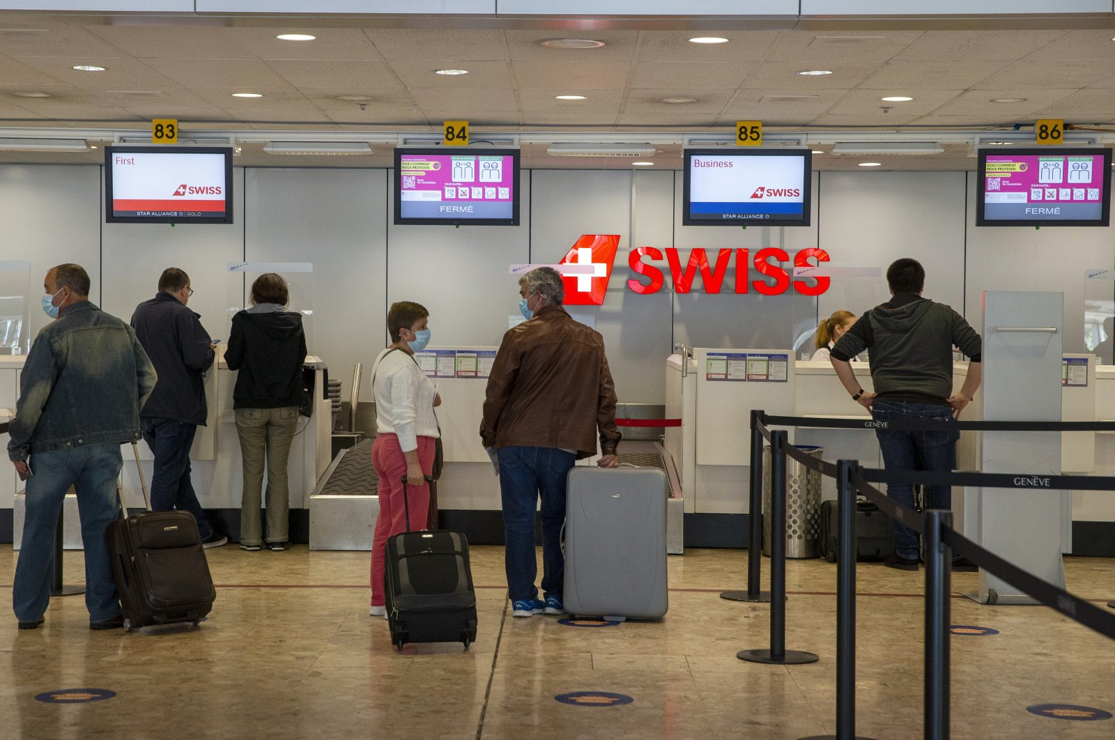 Passengers queue at check-in at Geneva Airport during the lifting of coronavirus COVID-19 lockdown regulations, Geneva, Switzerland, June 15, 2020. (AP Photo)